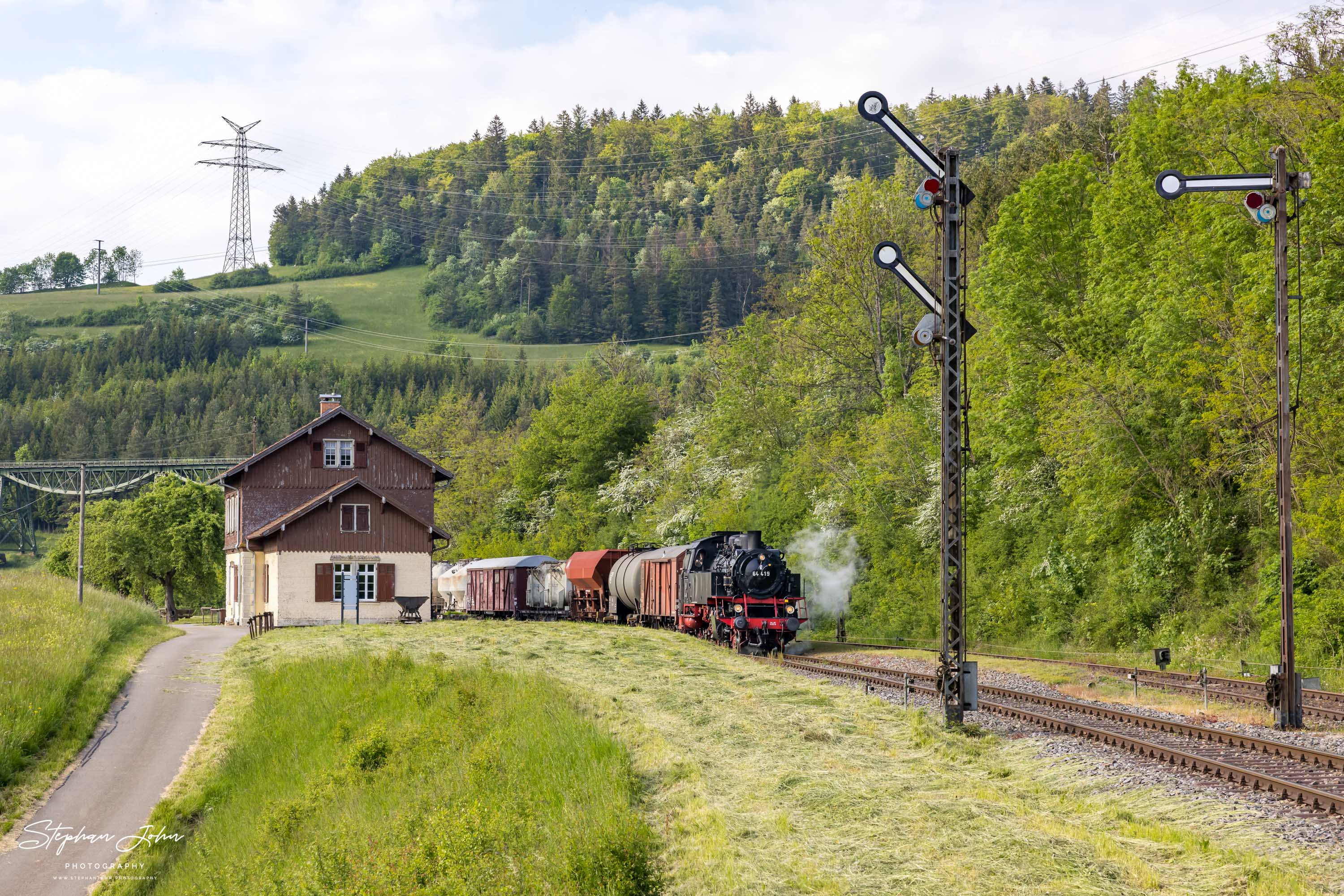 Lok 64 419 mit einem Güterzug nach Blumberg fährt aus dem Bahnhof Epfenhofen aus